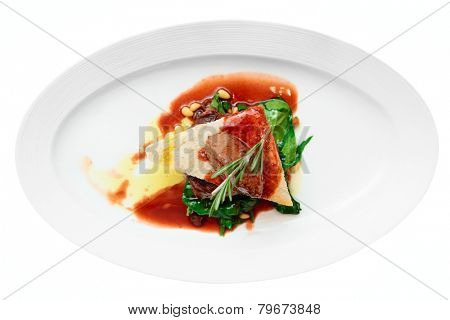Tenderloin steak with beef terrine and spinach isolated on white