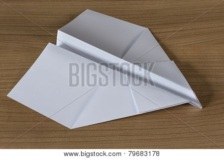 Paper Plane On A Wooden Table