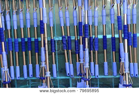 Blue Tool Handles To Wash The Glasses Of The Large Windows