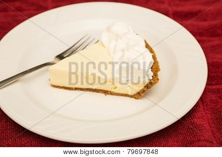 Slice Of Key Lime Pie On White Plate And Red Towel