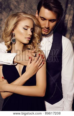 Beautiful Sensual Couple In Elegant Clothes Posing In Studio
