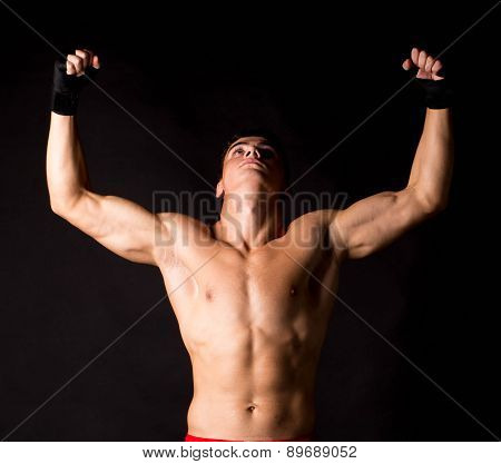 Portrait of boxer posing studio in gloves.