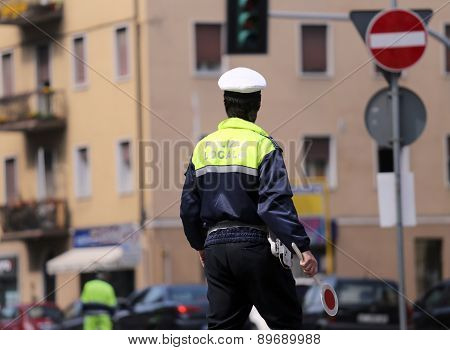 Italian Policeman In Uniform While Blocking Traffic With The Red Paddle