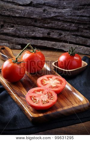 Cool Fresh Tomatoes, Whole And Half On Wooden Tray And Wooden Background