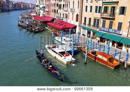 VENICE, ITALY - SEPTEMBER 2014 : Gondolas, public boats, water taxis and other private boats navigating the Grand Canal in Venice, Italy on September 15, 2014. 