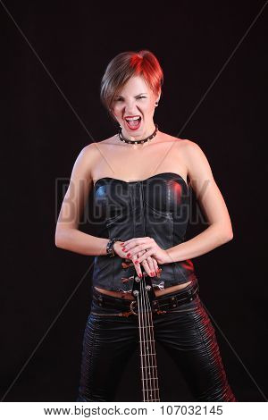 Sexy girl in leather clothes with bass guitar