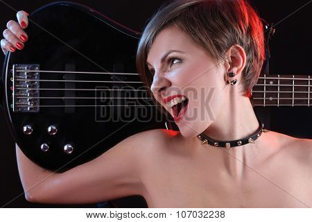 Sexy girl in leather clothes with bass guitar