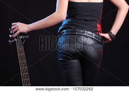 Sexy girl in leather clothes with bass guitar