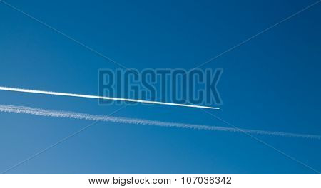 Long Tracks Of Airplane In The Blue Sky