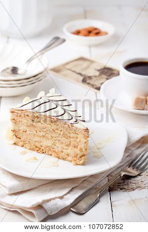 Traditional Hungarian Esterhazy cake with coffee cup and vintage postcards .