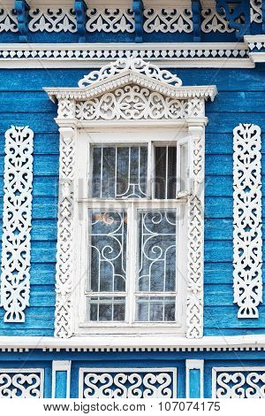 Window With Carved Patterns On Old Blue Wooden House