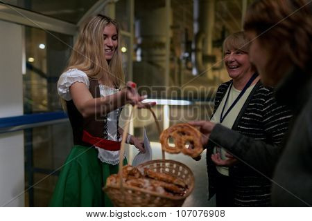 ST. PETERSBURG, RUSSIA - OCTOBER 24, 2015: People taste pretzels during the October Beer Festival at the Baltika - St Petersburg brewery. The brewery is providing guided tours to the plant regularly