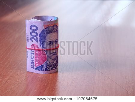 Bank Roll Of Ukrainian Hryvnia On The Table