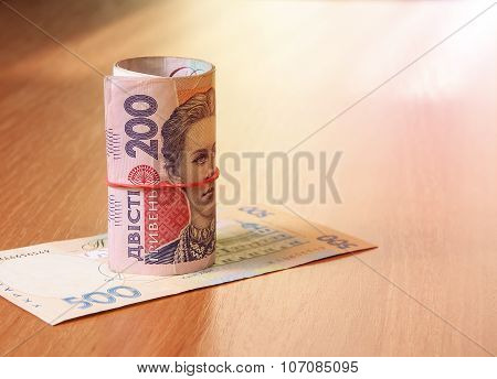 Bank Roll Of Ukrainian Hryvnia On The Table