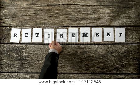 Male Hand Assembling The Word Retirement