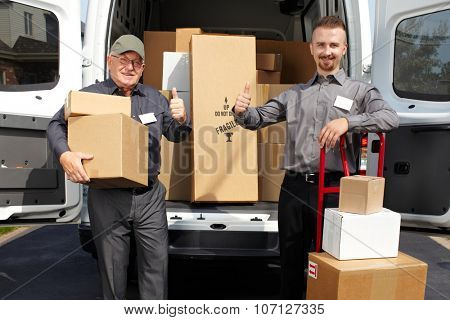 Group of delivery men with parcels near shipping truck. Parcel service.