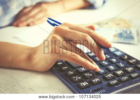 Accounting concept.Analyzing finance report with calculator