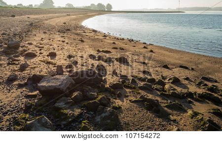 Riverside With Some Stones Early In The Morning