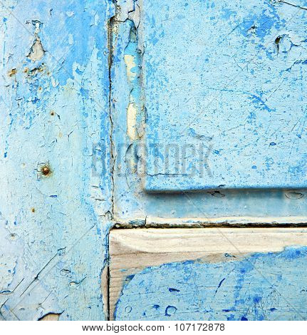 Dirty Stripped Paint In The Blue Wood Door And Rusty Nail