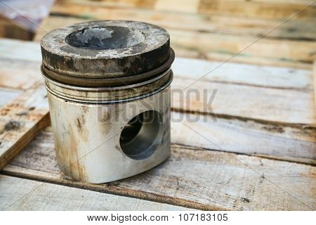 piston of engine on wooden background, Auto parts industry and spare parts background, piston damage