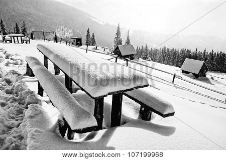 Table And Bench Covered By Fresh Snow After Blizzard