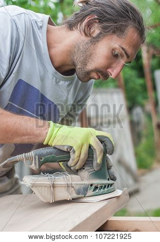 Carpenter Using Electric Sander