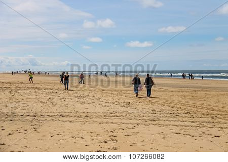 People On Sandy Beach Near North Sea In Zandvoort, The Netherlands