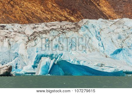Massive glacier descends into the water.  The picturesque  shore of Lake Viedma. In the water ice-floes, broken away from glacier