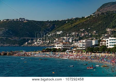 Populous beach in resort near mountains
