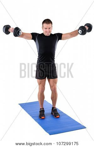 young man fitness instructor shows finishing position of standing dumbbell lateral raise, isolated on white