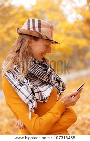Girl Near Autumn Tree With Phone
