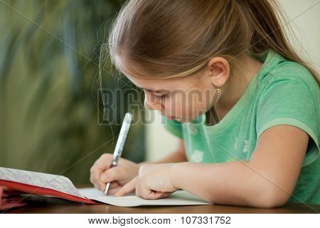 Pre-adolescent Girl Concentrates On Her Studies