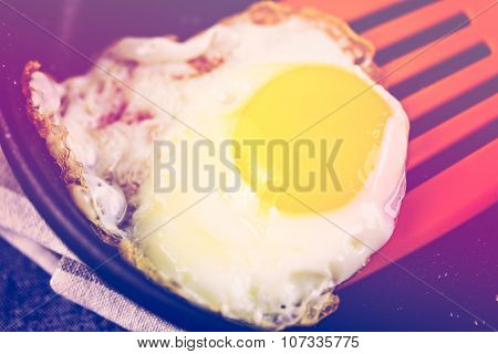 Fresh crispy egg on small frying pan.
** Note: Shallow depth of field