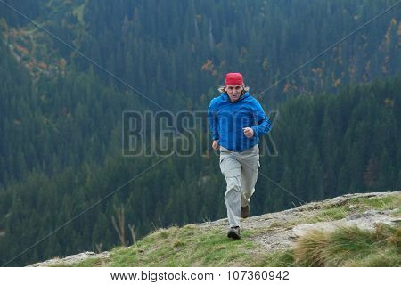advanture man with backpack hiking on mountain forest