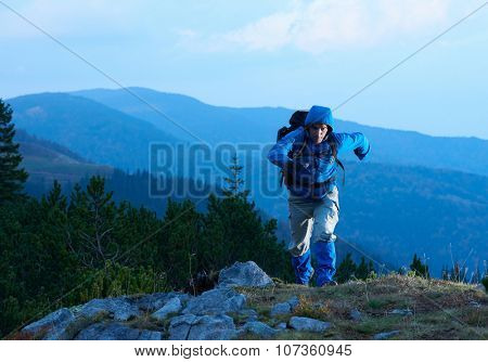 advanture man with backpack hiking on mountain forest