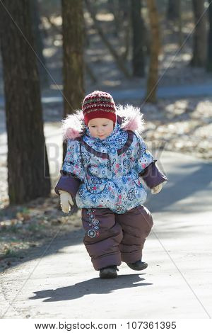 Little Adorable Girl Toddling Without Help In Cold Weather Park