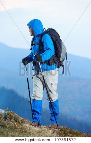 advanture man with backpack hiking on mountain forest