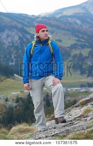 advanture man with backpack hiking on mountain forest