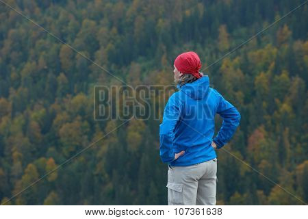 advanture man with backpack hiking on mountain forest