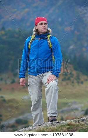 advanture man with backpack hiking on mountain forest