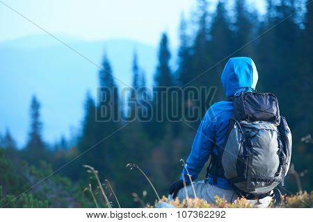 advanture man with backpack hiking on mountain forest