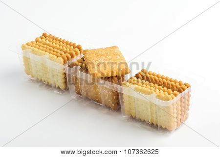 Biscuits pile in the plastic trays on white background