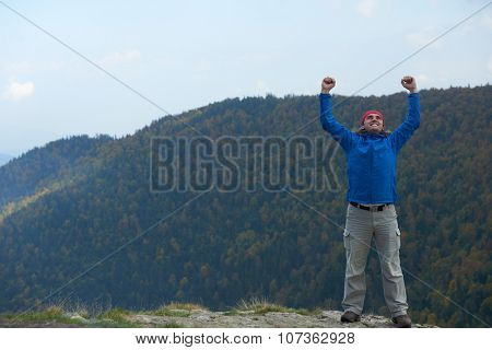 advanture man with backpack hiking on mountain forest