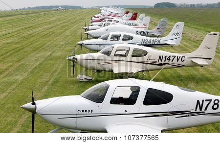 Prague, CZECH REPUBLIC - 22 May 2010: Cirrus aircraft series in the meadow in the background Airbus