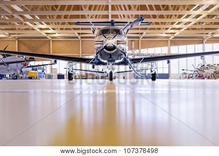 Single Turboprop Aircraft Pilatus Pc-12 In Hangar. Stans, Switzerland, 29Th November 2010.