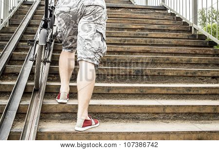 Cyclist Up The Stairs Of The Bridge And Bike Trails Along The Ramp