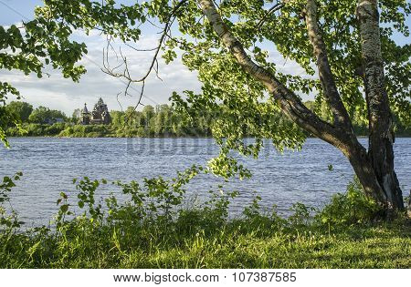 Birch Stands On The Bank, In The Background An Old Church