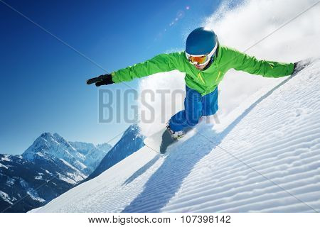 Snowboarder skiing in high mountains.
