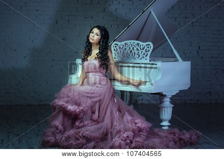 In A Dark Room Girl Sitting At The Piano.
