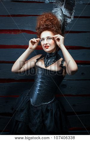 Old-fashioned Girl In A Corset And High Hairdo.